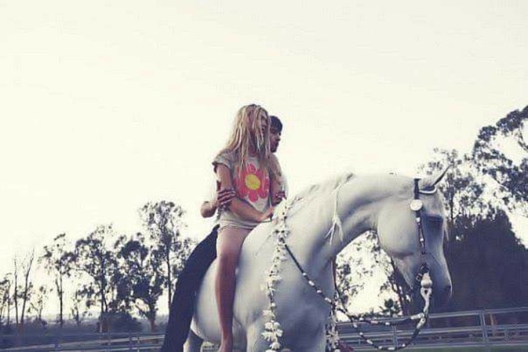 Мужчина привел лошадь. Блондинка на коне. Девушка верхом на лошади со спины. Блондинка на лошади со спины. Блондинка на белой лошади.